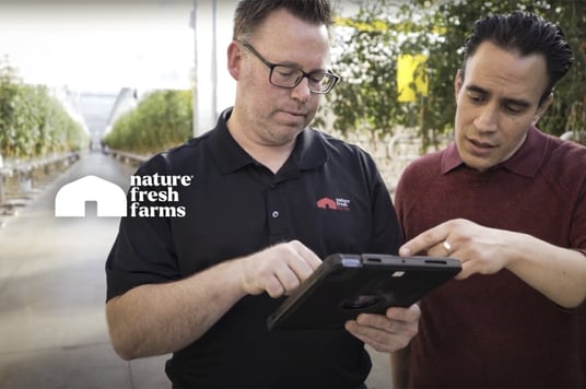 Nature Fresh Farms - Two Men Discussing with Tablet